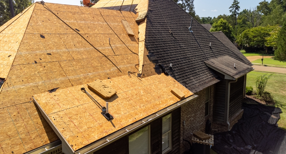 House,with,new,roof,being,installed,after,hail,damage